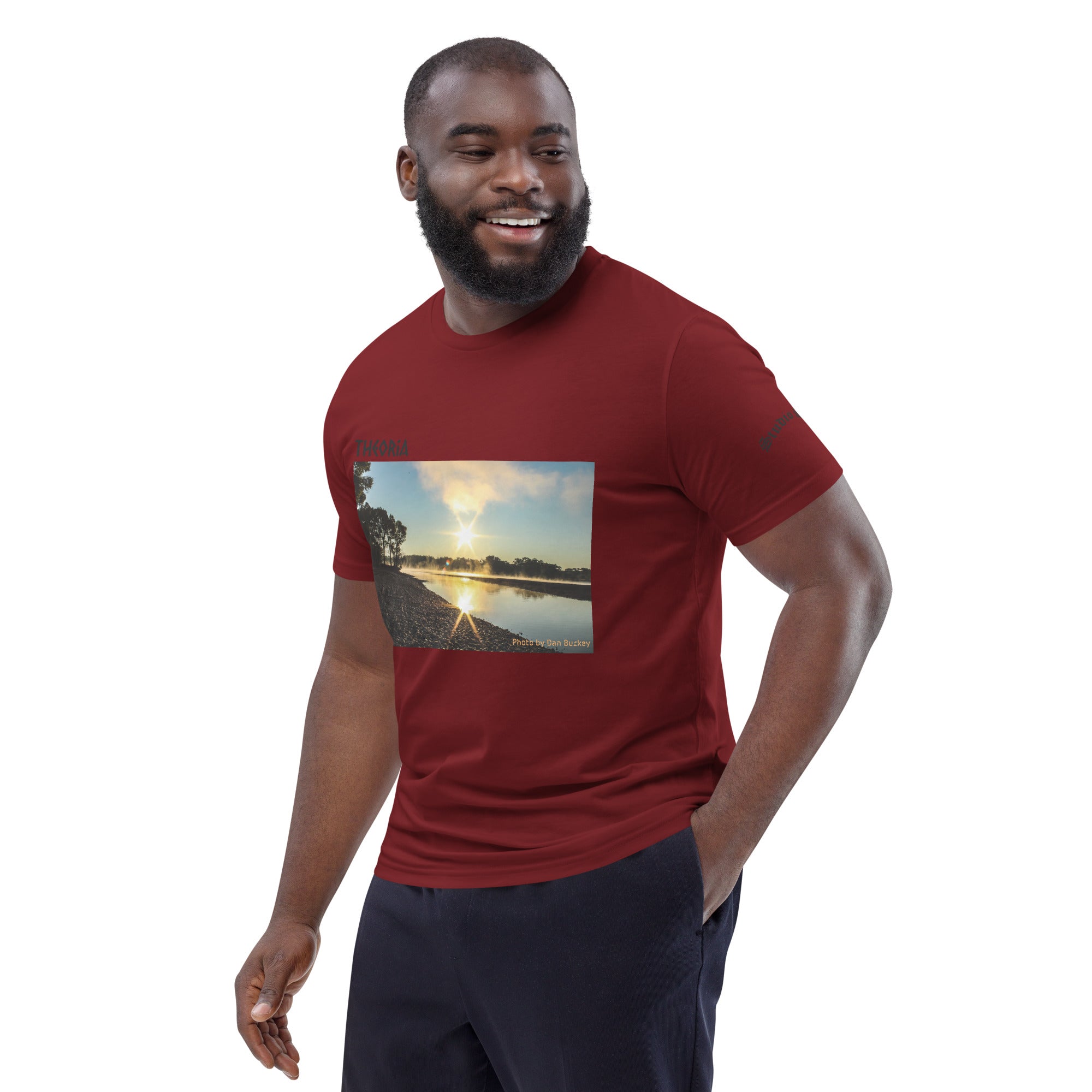 Man wearing a red t-shirt with a nature graphic on a white background