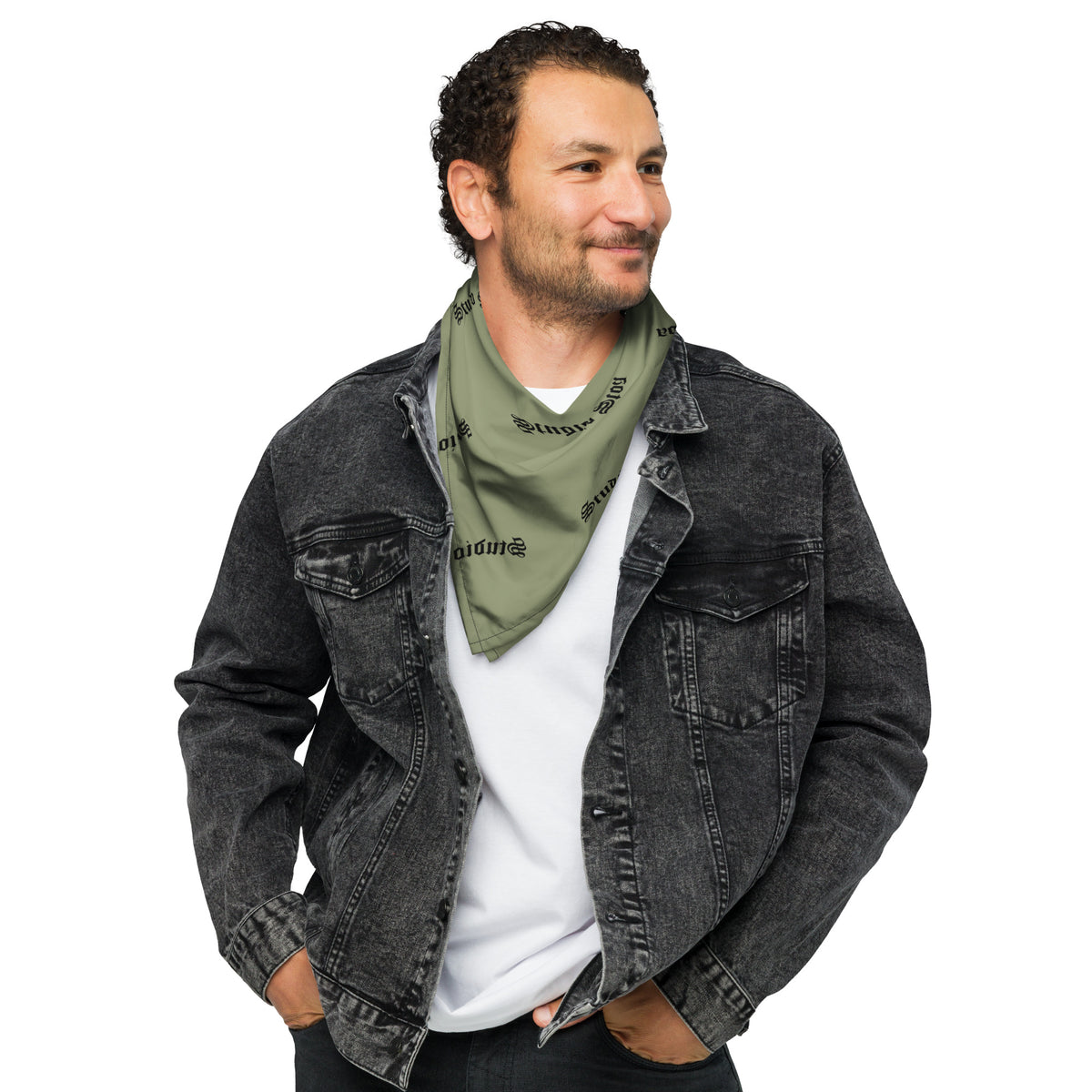 A man wearing an olive green square bandana featuring a horizontal black-and-white American flag stripe pattern across the center, with a repeating black 'studio stoa' logo printed all over the fabric.
