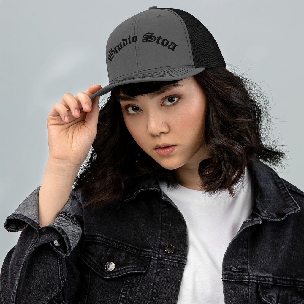 female model wearing Studio Stoa Trucker Cap charcoal black snapback front view