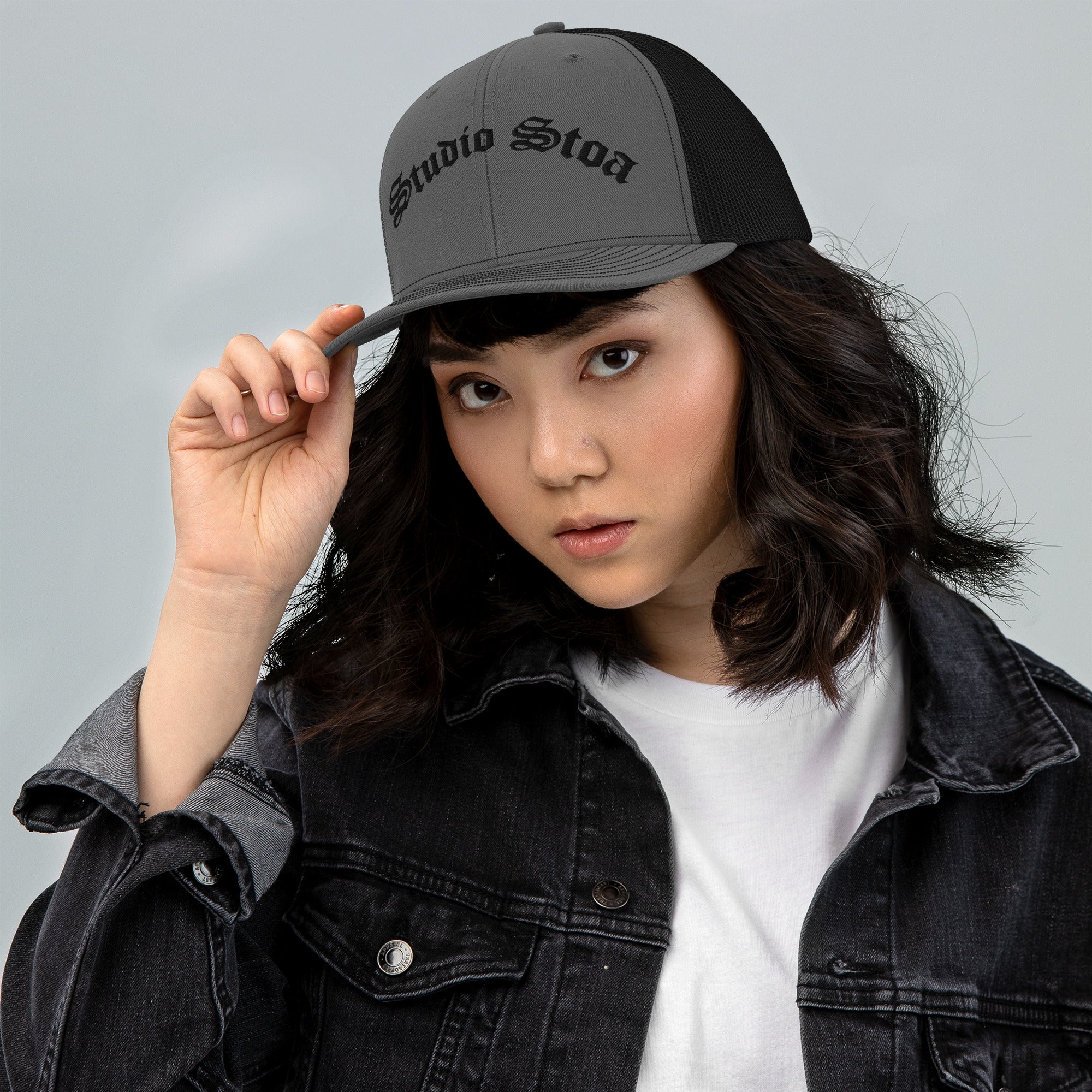 female model wearing Studio Stoa Trucker Cap charcoal black snapback front view
